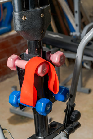 Dumbbells and resistance band on gym equipment.