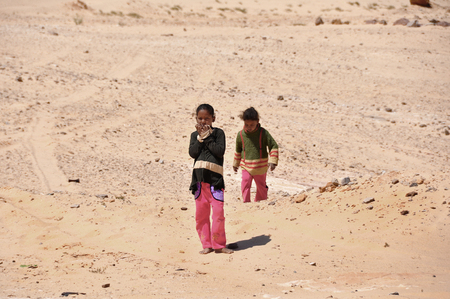 Egypt, Sinai Peninsula, Bedouin children, portrait of girl, sunburnt face, worn clothing, a sad lookのeditorial素材