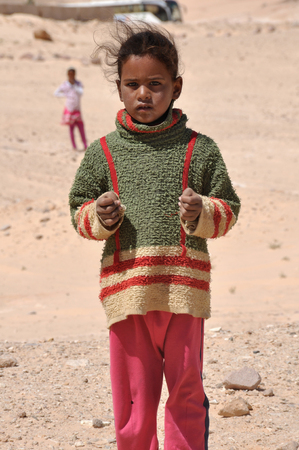 Egypt, Sinai Peninsula, Bedouin children, portrait of girl, sunburnt face, worn clothing, a sad lookのeditorial素材
