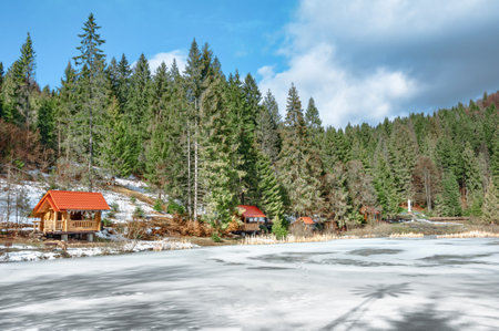 Sunny winter morning in the resort area of the Carpathian mountain lake Vita.の写真素材