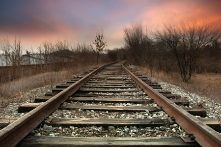 Railway tracks at sunset. Beautiful landscape with old railroad tracks.の写真素材
