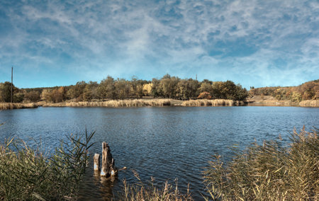 Autumn landscape with lake and blue sky. beautiful natural background.の写真素材