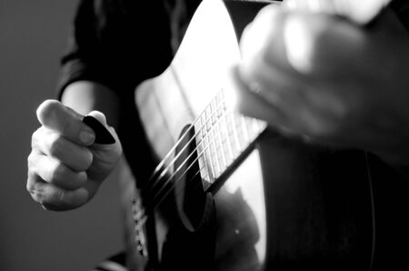 Man playing on acoustic guitar, a pleasant, relaxing day, music and sound concept, Closeup