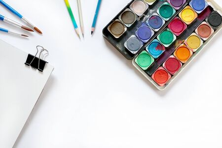 Watercolor paintbox and brushes on white background. Flat lay, top viewの写真素材