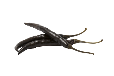 dried black chili peppers on white backgroundの写真素材