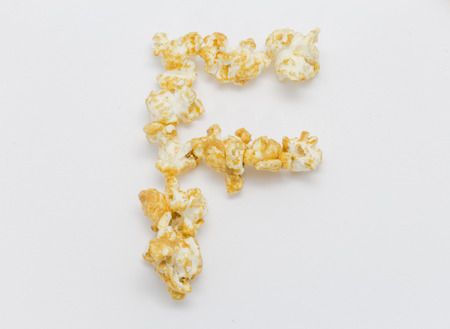 pop corn forming letter F isolated on white backgroundの写真素材