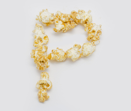pop corn forming letter P isolated on white backgroundの写真素材
