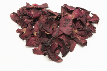 Heart Shape withered roses petal isolated on white backgroundの写真素材