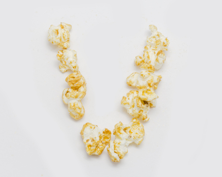pop corn forming letter V isolated on white backgroundの写真素材