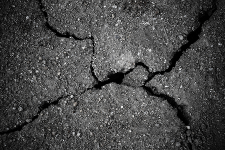 ground dirt soil texture with crack from heatの写真素材