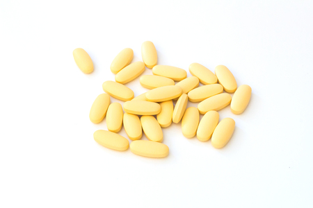 vitamin c pill isolated on whiteの写真素材
