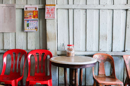 A "kopitiam" (coffee shop) opens its doors along the wooden shophouses in Semerah, a transit town between Muar and Batu Pahat in the state of Johor, Malaysia.のeditorial素材