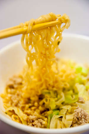 chopsticks,bowl and noodles on white backgroundの写真素材