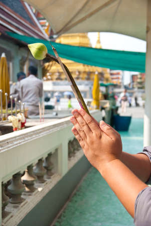 Pray, man hold joss stick and lotus praying at temple.の写真素材