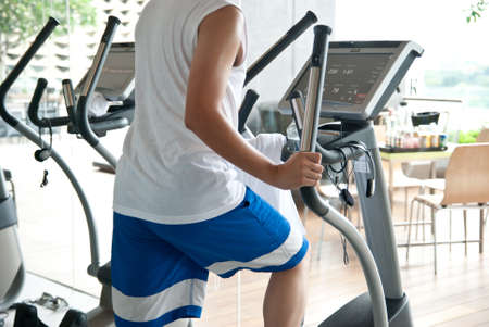Healthy Young at the gym exercising on the xtrainer machinesの写真素材