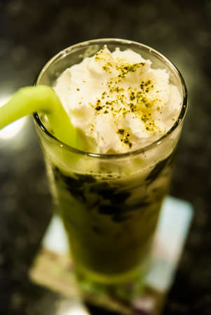 glass of green tea smoothies decorate with milkの写真素材