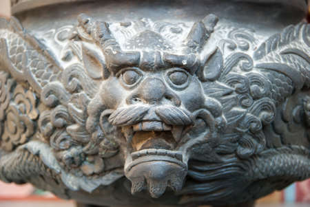 The Dragon incense burner in front of a historical Thailand temple の写真素材