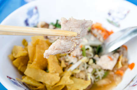 Noodles spicy in bowl and chopsticks の写真素材