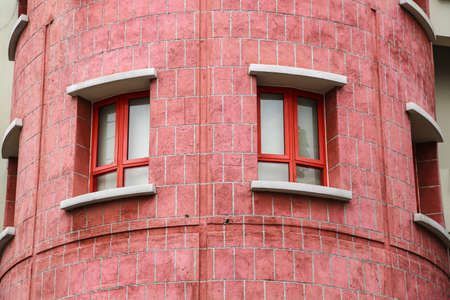 Two colorful windows on an old wallの写真素材