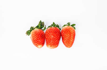 Three fresh strawberries isolated on white backgroundの写真素材