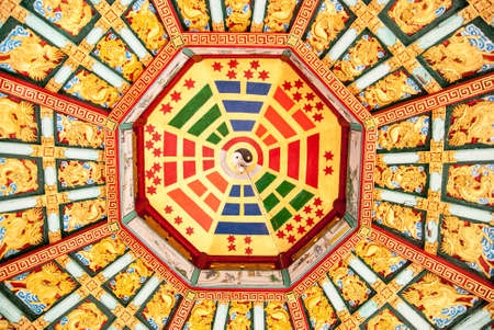 Colorful ceiling inside Chinese temple, showing popular Feng Shui sign, balance between wind and water.の写真素材