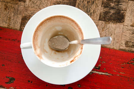 An empty cup of coffee viewed from above on a wooden tableの写真素材