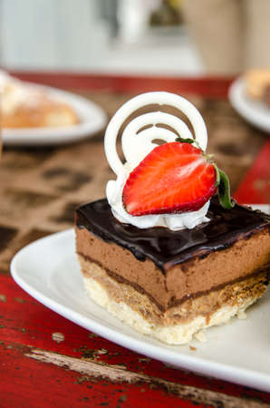 Piece of chocolate cake with  fresh strawberry on wooden backgroundの写真素材