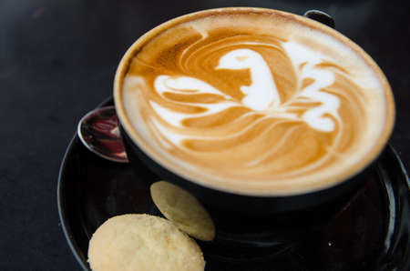 A cappuccino with a bird in latte artの写真素材