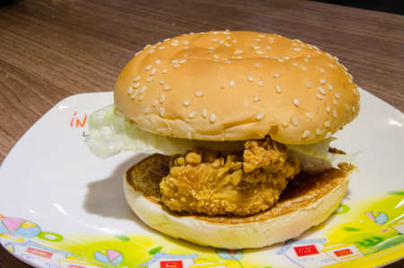 chicken burger on a sesame seed bunの写真素材
