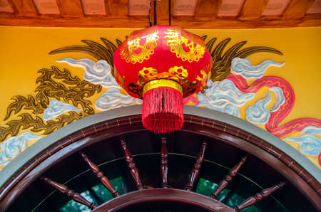 illuminated chinese lantern hanging in buddhist templeの写真素材