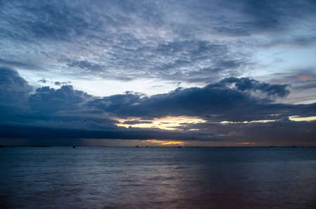 Summer sun goes down over the oceanの写真素材