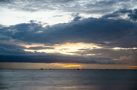 Summer sun goes down over the oceanの写真素材