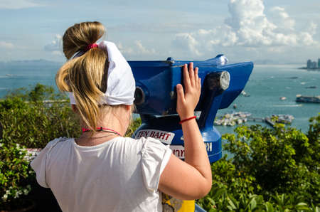 girl looking through binoculars looking through binocularsの写真素材