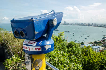 A coin-operated binocular viewer overlooking a vast vista