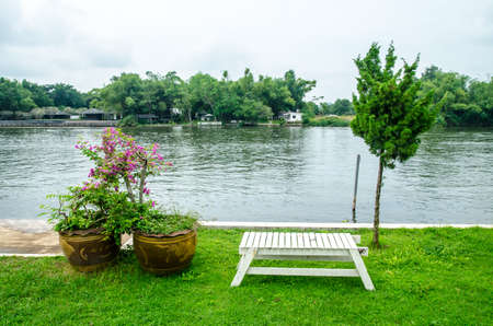 Wooden bench at the lakeの写真素材
