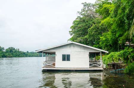 House on stilts over the riverの写真素材