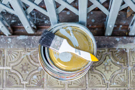 Full of grey paint tin and paint brush set at the doorの写真素材