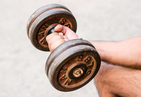 Arm attractive athletic man with dumbbellsの写真素材