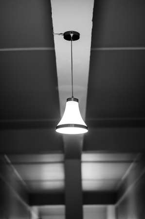 Old dusty light bulb glowing on the inside of a hotelの写真素材