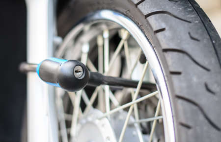 Security lock blocking the motorcycle wheelの写真素材