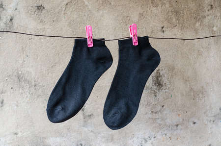 The black socks made of a clap, hang on a wireの写真素材