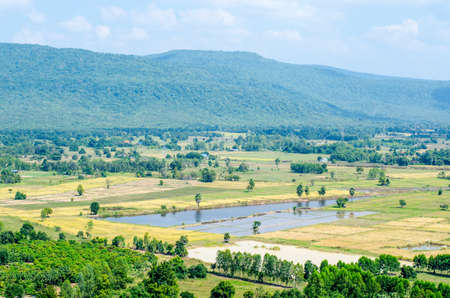 Lookout point with green fields and mountainsの写真素材