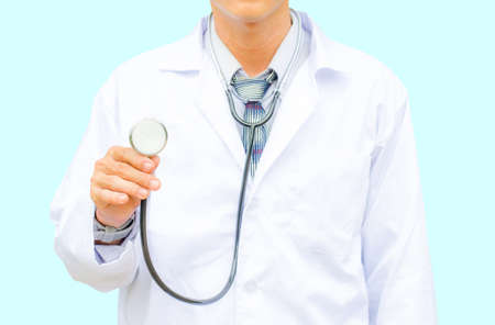 Doctor with a stethoscope in the hands and isolated on blue backgroundの写真素材