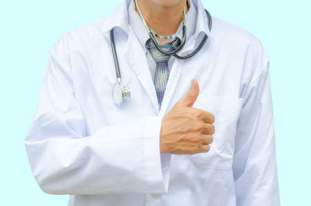 Male doctor showing his thumbs up, isolated on blue backgroundの写真素材