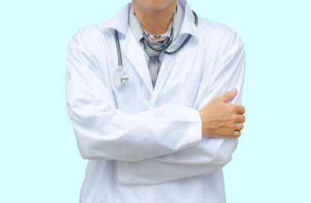 Doctor with stethoscope standing with arms crossed isolated on a blue backgroundの写真素材