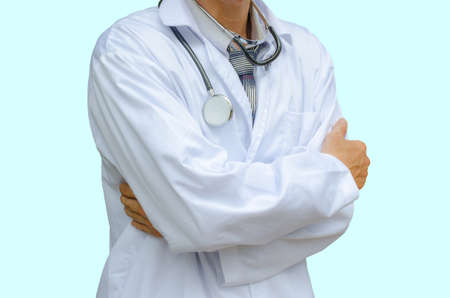 Doctor with stethoscope standing with arms crossed isolated on a blue backgroundの写真素材
