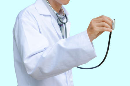 A doctor listening with a stethoscope,isolated on blue backgroundの写真素材