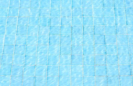 blue tiles swimming pool water reflection texture image is backgroundの写真素材
