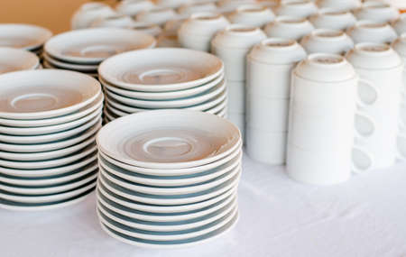 a lot of white plates and coffee cup in a hotelの写真素材