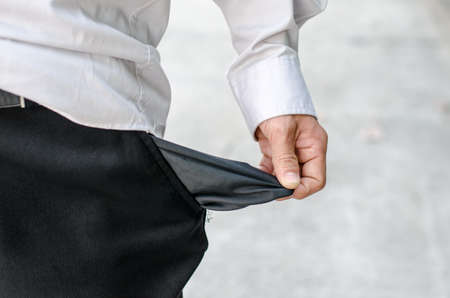 Business man showing close up his empty pocketの写真素材